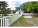 Home's front yard with a white picket fence at 4622 Paloverde Dr, New Port Richey, FL 34652