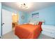Bedroom with orange bedding and view of dining area at 4622 Paloverde Dr, New Port Richey, FL 34652