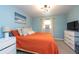 Bright bedroom with orange bedding and a dresser at 4622 Paloverde Dr, New Port Richey, FL 34652