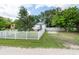 White house with a white picket fence and green lawn at 4622 Paloverde Dr, New Port Richey, FL 34652