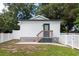 Charming studio with a fenced backyard, patio, and steps leading to the entrance at 4622 Paloverde Dr, New Port Richey, FL 34652