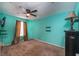 Bedroom with teal walls, ceiling fan, and window with curtains at 807 Hunters Ct, Brandon, FL 33511