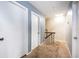 Upper hallway with neutral carpeting and doors to bedrooms at 807 Hunters Ct, Brandon, FL 33511