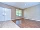 The foyer has wood floors, a large window, and a white front door with a black door handle at 5365 Shasta Daisy Pl, Land O Lakes, FL 34639