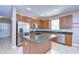 Well-equipped kitchen with stainless steel appliances, granite countertops, and center island at 5365 Shasta Daisy Pl, Land O Lakes, FL 34639
