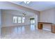 Open-concept living area with tiled floors, archways, large windows with curtains, and bar area at 5365 Shasta Daisy Pl, Land O Lakes, FL 34639