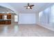 Bright living room features tile floors, modern ceiling fan, archway and lots of natural light at 5365 Shasta Daisy Pl, Land O Lakes, FL 34639