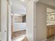 Hallway with tile flooring, a half-wall separating it from another room, and doorways at 5527 Riddle Rd, Holiday, FL 34690