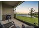 Screened porch with lake view, outdoor grill, and seating at 7828 Stonebrook Cir, Wesley Chapel, FL 33545