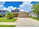 Two-story house with solar panels and red shutters at 5365 Shasta Daisy Pl, Land O Lakes, FL 34639