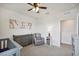 Bedroom with crib, dresser, and seating area at 11824 Myrtle Rock Dr, Riverview, FL 33578