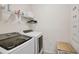 Bright laundry room with washer, dryer, and ample shelving at 11824 Myrtle Rock Dr, Riverview, FL 33578