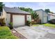 One-story home viewed from the street with front yard landscaping and attached garage at 12518 Cobble Stone Dr, Hudson, FL 34667