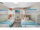 Bright bunk bedroom with orange curtains and twin bunkbeds, offering ample sleeping space at 944 Apollo Beach Blvd, Apollo Beach, FL 33572