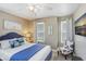 Well-lit bedroom featuring a blue accent bed, coastal decor, and natural light from bright windows at 944 Apollo Beach Blvd, Apollo Beach, FL 33572