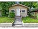 Tan house with white door and steps at 405 E Dr Martin Luther King Jr Blvd, Tampa, FL 33603