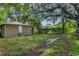 Backyard view of detached building, large tree, and neighboring homes at 405 E Dr Martin Luther King Jr Blvd, Tampa, FL 33603