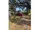 Property features a spacious front yard with mature trees and ample parking at 405 E Dr Martin Luther King Jr Blvd, Tampa, FL 33603