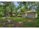 Backyard view of detached building, large tree, and neighboring homes at 405 E Dr Martin Luther King Jr Blvd, Tampa, FL 33603