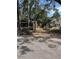 View down a tree-lined alley with a wooden fence at 405 E Dr Martin Luther King Jr Blvd, Tampa, FL 33603