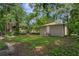 Backyard view of detached building, large tree, and neighboring homes at 405 E Dr Martin Luther King Jr Blvd, Tampa, FL 33603