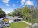 Aerial view of a house with a green lawn and driveway at 7024 Filbert Ln, Tampa, FL 33637