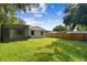 Backyard view of house, fence and shed at 7024 Filbert Ln, Tampa, FL 33637