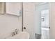 Simple bathroom with vanity, mirror, and access to other rooms at 7024 Filbert Ln, Tampa, FL 33637