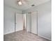 Spacious bedroom with ceiling fan, door to hallway, and built-in closet at 7024 Filbert Ln, Tampa, FL 33637