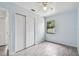 Light and airy bedroom featuring a ceiling fan and sliding door closet at 7024 Filbert Ln, Tampa, FL 33637