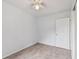 Well-lit bedroom with ceiling fan, door to hallway, and tile floors at 7024 Filbert Ln, Tampa, FL 33637