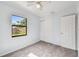 Bedroom with window, ceiling fan, and tile floors at 7024 Filbert Ln, Tampa, FL 33637