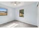 Bedroom with two windows, ceiling fan, and tile floors at 7024 Filbert Ln, Tampa, FL 33637