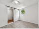 Bright bedroom with tile floors and barn door leading to laundry at 7024 Filbert Ln, Tampa, FL 33637