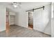 Bedroom with tile floors, shelving, and barn door to laundry at 7024 Filbert Ln, Tampa, FL 33637