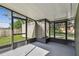 Screened porch with concrete floor and shed view at 7024 Filbert Ln, Tampa, FL 33637