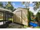 Tan storage shed with vines and blue tarp at 7024 Filbert Ln, Tampa, FL 33637