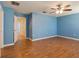 Bright bedroom with light blue walls and wood floors at 18933 Sunterra Dr, Land O Lakes, FL 34638