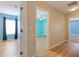 Hallway with light walls and wood flooring, connecting bedrooms at 18933 Sunterra Dr, Land O Lakes, FL 34638