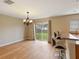 Dining room with hardwood floors, chandelier, and sliding glass doors at 18933 Sunterra Dr, Land O Lakes, FL 34638