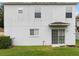 Two-story house back elevation, featuring multiple windows and a sliding glass door leading to the backyard at 18933 Sunterra Dr, Land O Lakes, FL 34638