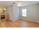 Light-blue bedroom with wood flooring, ceiling fan, and access to bathroom at 18933 Sunterra Dr, Land O Lakes, FL 34638