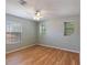 Empty bedroom with light walls, wood flooring, and window blinds at 18933 Sunterra Dr, Land O Lakes, FL 34638