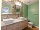 Modern bathroom with double vanity, tile backsplash, and updated fixtures at 18933 Sunterra Dr, Land O Lakes, FL 34638