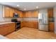 Kitchen with light wood cabinets and stainless steel appliances at 18933 Sunterra Dr, Land O Lakes, FL 34638