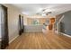 Open living room with hardwood floors and kitchen access at 18933 Sunterra Dr, Land O Lakes, FL 34638