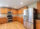 Kitchen with light wood cabinets and stainless steel appliances at 18933 Sunterra Dr, Land O Lakes, FL 34638