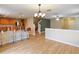 Dining room with hardwood floors, kitchen access, and stairs at 18933 Sunterra Dr, Land O Lakes, FL 34638