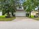 Two-story house with a white garage door and landscaping at 18933 Sunterra Dr, Land O Lakes, FL 34638