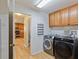 Laundry room with washer, dryer, and shelving at 18933 Sunterra Dr, Land O Lakes, FL 34638